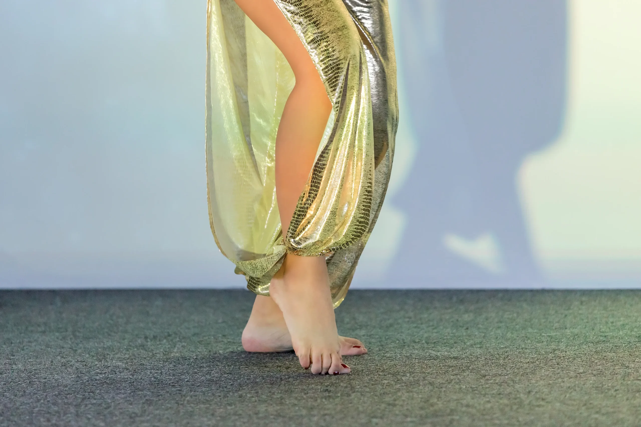 belly dancer feet position - sisu art academy woman in gold pants with side leg slit